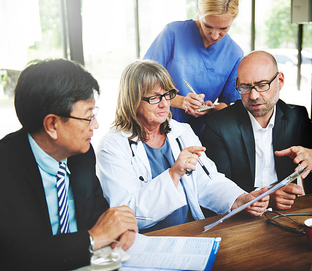 Doctor Team Treatment Plan Discussion Concept Doctor Team Treatment Plan Discussion Concept healthcare and medicine business hospital variation stock pictures, royalty-free photos & images