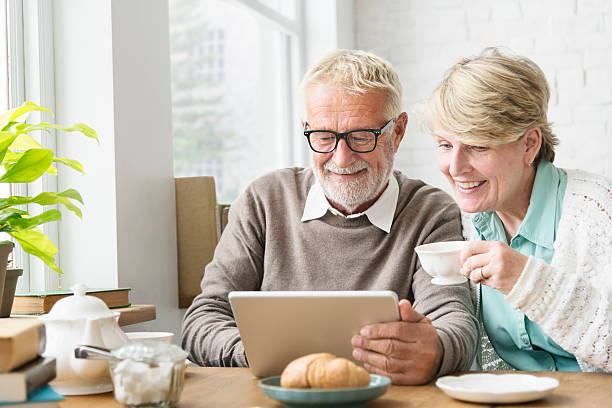 senior adult using digital device tablet concept - retirement planning imagens e fotografias de stock