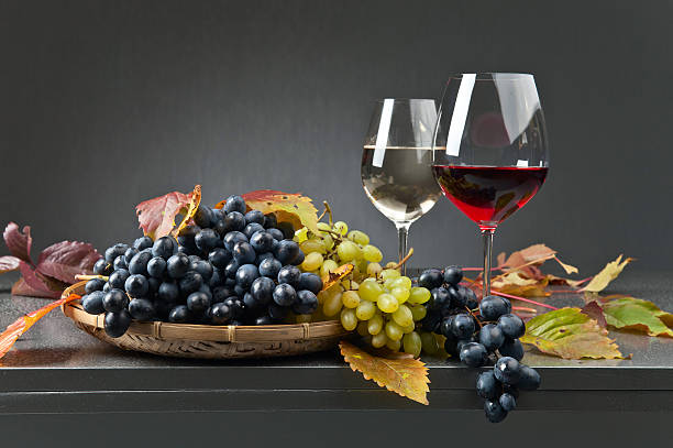 istock Blue and white grapes with glasses of wine 618336062