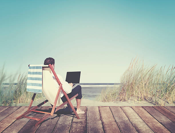 istock Businessman Working by the Beach Relaxation Concept 618336898