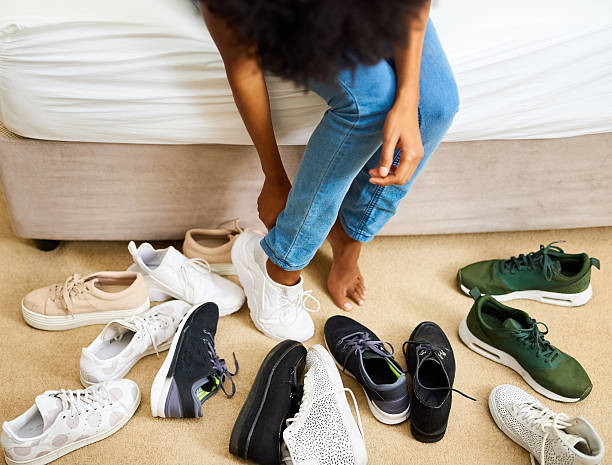 So many shoes, only two feet Cropped shot of a woman trying on different pairs of shoes canvas shoe photos stock pictures, royalty-free photos & images