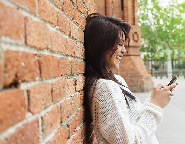 istock Beautiful woman texting on the phone 618338472