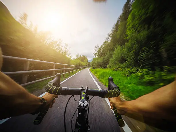 Really fast racing bicycle ride on mountain road. Action cam on a chesty mount for a POV filming view.