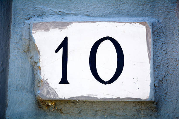 istock Door number five sign on plaster wall 618339536
