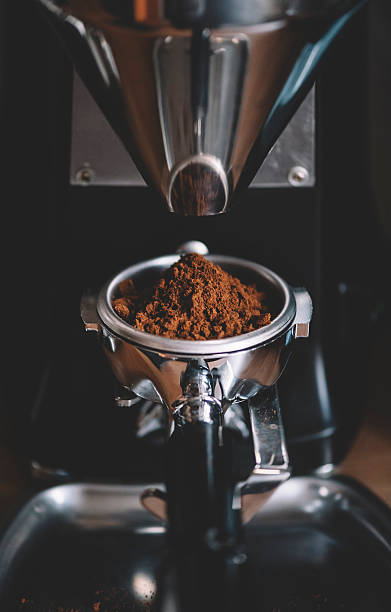 istock Coffee beans in a portafilter by the coffee grinder 618340102