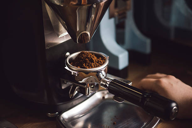 istock Coffee beans in a portafilter by the coffee grinder 618340212