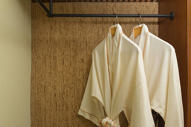 istock two bathrobes hanging in warmly design closet 618341666