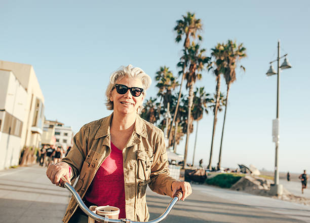 istock Senior woman with the bike 618343612