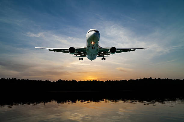 istock Airplane flying in the sky tropical sea at sunset time. 618343800