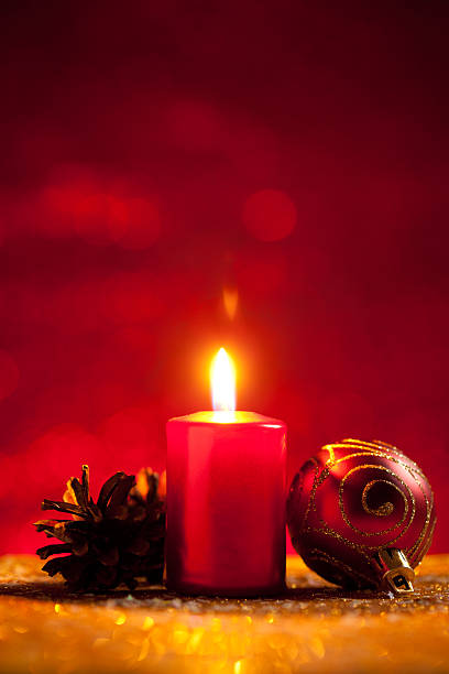 istock Candle and bauble on glitter with red background 618344394