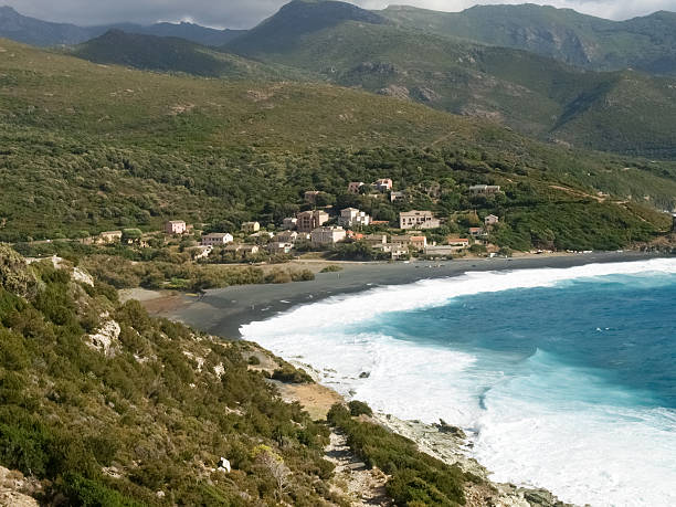 Beach with strong Mistral wind Corsica, France: Coast of Cap Corse and Nonza Beach in rough seas and strong Mistral wind mistral wind stock pictures, royalty-free photos & images
