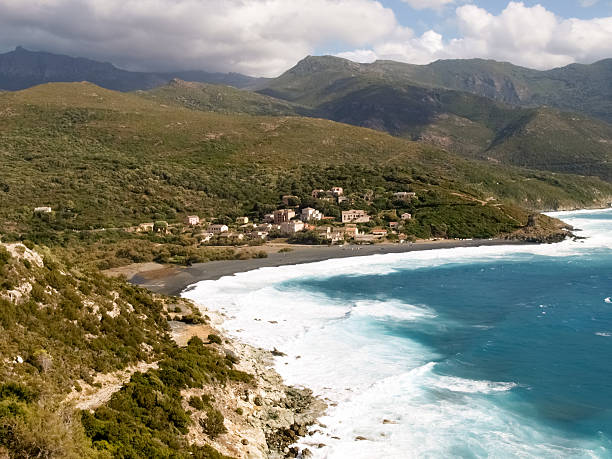 Beach with strong Mistral wind Corsica, France: Coast of Cap Corse and Nonza Beach in rough seas and strong Mistral wind mistral wind stock pictures, royalty-free photos & images