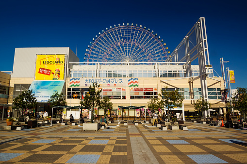Osaka, Japan - October 24, 2016: The Tempozan Harbor Village shopping center, with the Tempozan Ferris Wheel in the background.