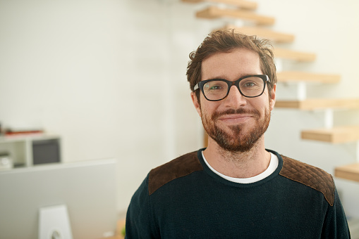 Portrait of a confident young entrepreneur standing in his office