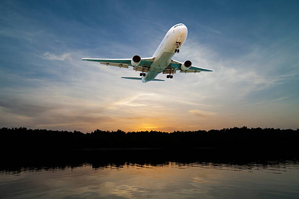 istock Airplane flying in the sky tropical sea at sunset time. 618349578