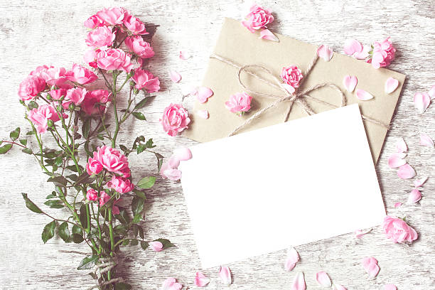 istock Bouquet of tender roses with blank greeting card and envelope 618349722