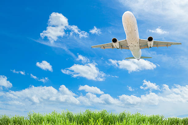 istock Airplane in the sky with beautiful green grass blue sky 618349994