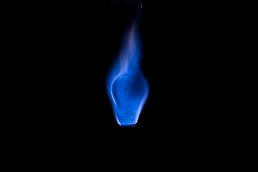 Tungsten light bulb burning with a beautiful blue flame