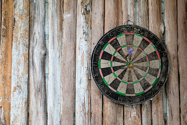 istock Old dart board on wooden background 618353474