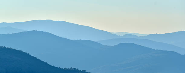 istock Blue shades on mountains at the horizon at sunset 618353640