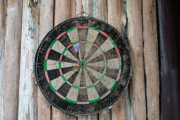 istock Old dart board on wooden background 618353992