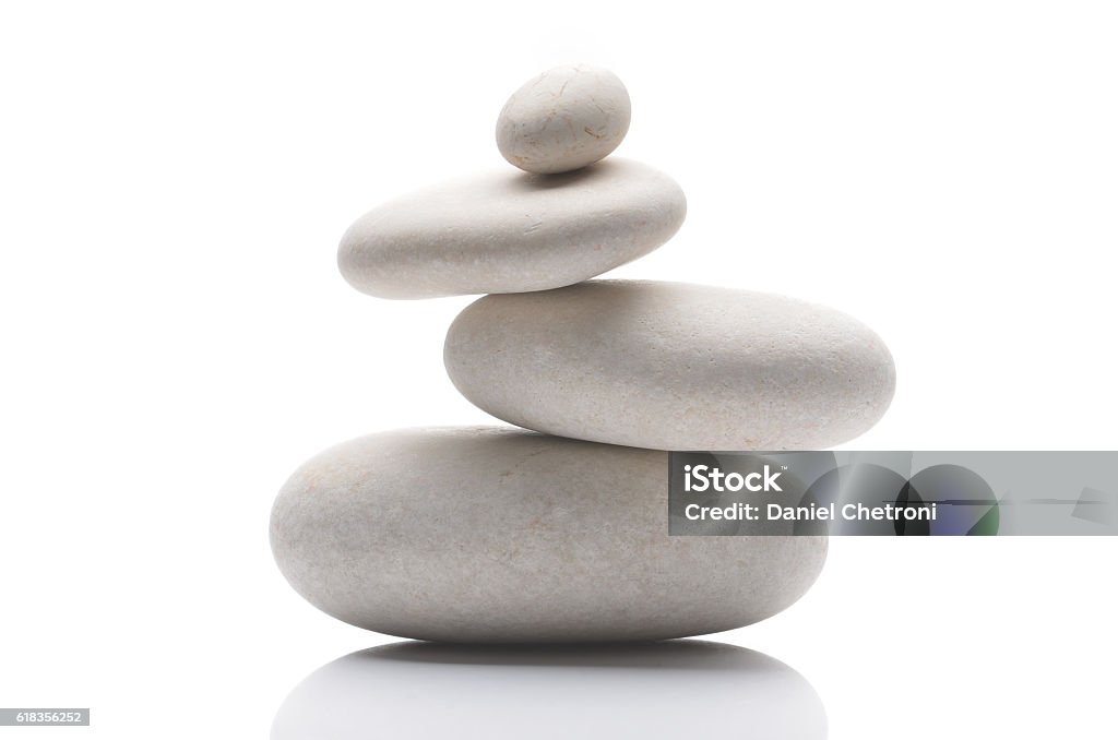 Guijarros equilibrados, aislados sobre fondo blanco con reflejo - Foto de stock de Equilibrio libre de derechos