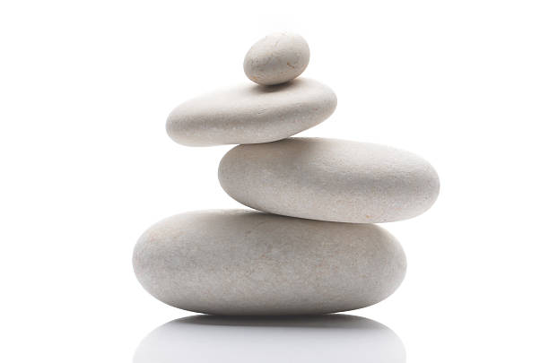 balanced pebbles, isolated on white background with reflection - balance imagens e fotografias de stock