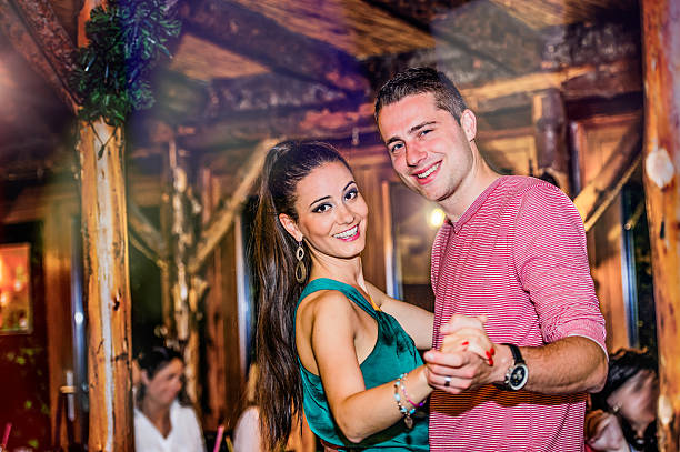 istock Young beautiful couple dancing in bar or club 618357398