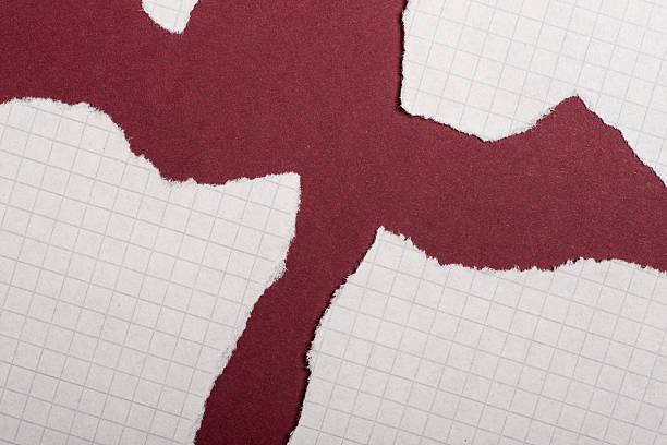 istock Pieces of torn paper over the dark red background 618357672