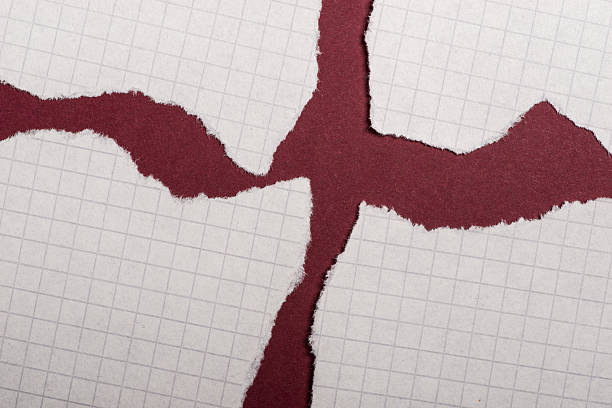 istock Pieces of torn paper over the dark red background 618357738