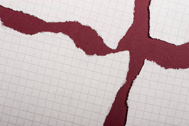 istock Pieces of torn paper over the dark red background 618357812
