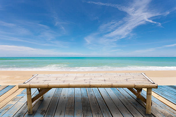 istock Wooden bamboo sunbeds on old wood ,beautiful beach 618359012