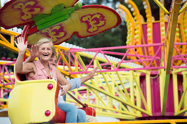 istock Senior couple in amusement park 618359498