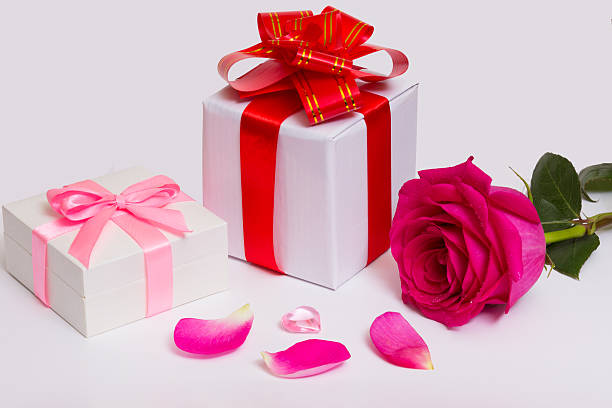istock Gift boxes with bows, red ribbons, rose and petals. 618359946