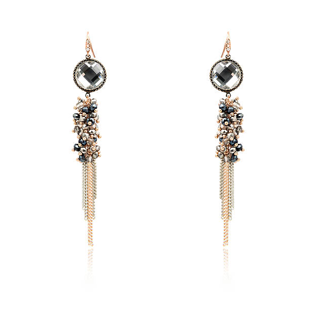 istock Pair of golden diamond earrings isolated on white 618359974