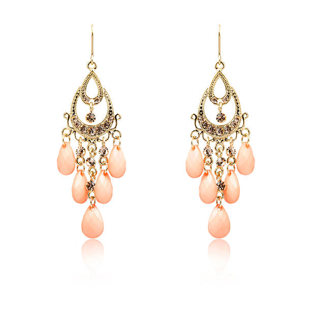 istock Pair of golden diamond earrings isolated on white 618360060