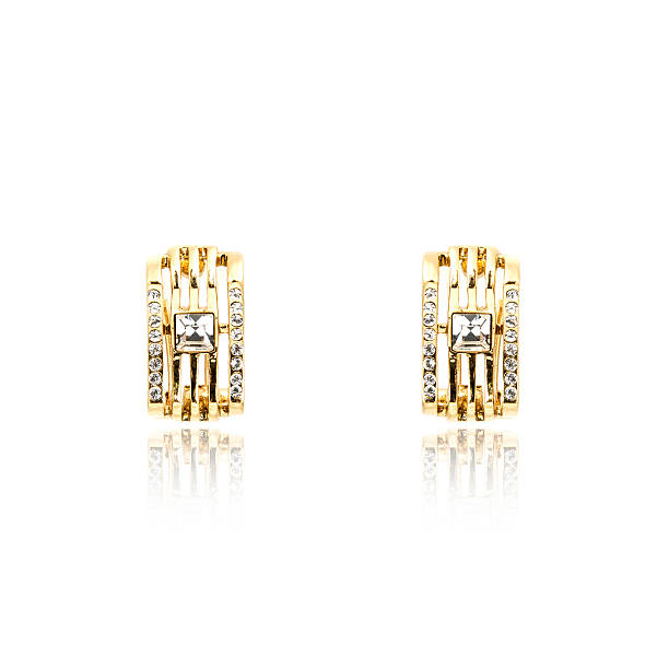 istock Pair of golden diamond earrings isolated on white 618360076