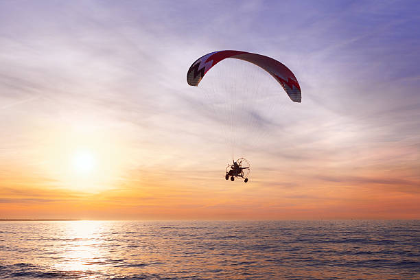 istock Motor Glider flying over the sea during sunset 618360964