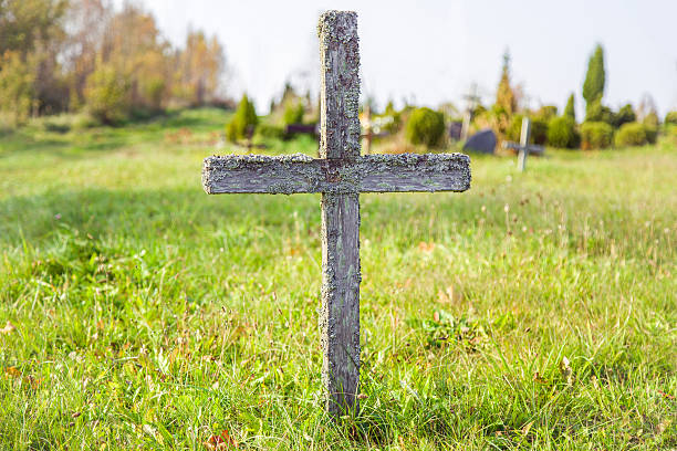 abandoned, old, wooden cross in the cemetery in sunny day. - cross shape religion sky wood imagens e fotografias de stock