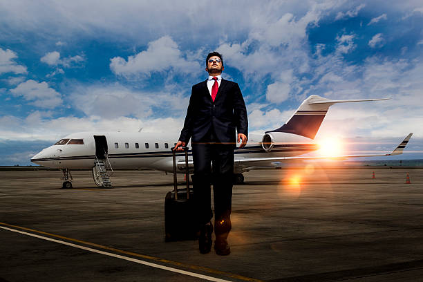 istock Businessman walking away from private jet after flight 618363114