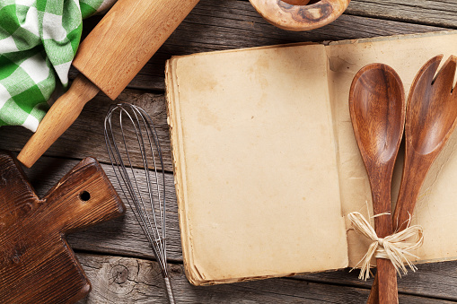 Blank vintage recipe cooking book and utensils. Top view with copy space