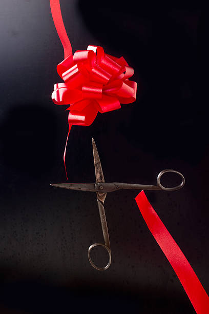 istock Scissors cut bow of tape 618421744