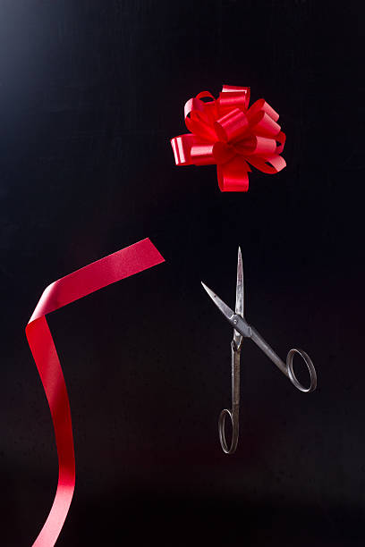 istock Scissors cut bow of tape 618422240