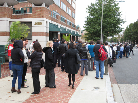 Washington DC, USA-October 27, 2016:  These people were spotted outside a retail office complex on Wisconsin Avenue in Northwest Washington DC.  They are evacuating the building owing to a fire alarm and waiting to be let back in once it is safe to go back inside.