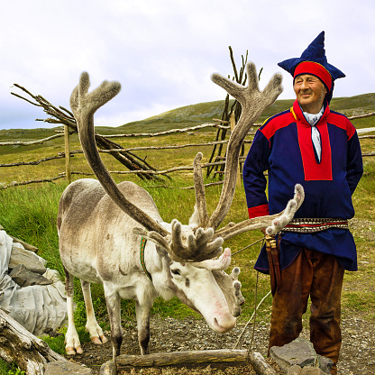 Honningsvag, Norway.- September 16, 2016: Deer and reindeer breeder dressed in national clothes the Sami in Honningsvag, Norway. The Sami are the people inhabiting the Arctic