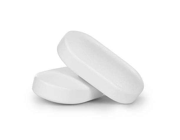 istock close-up of two pills isolated on white background 618423162