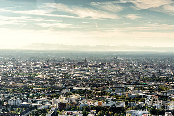 arial view over munich with Frauenkirche and mountain range