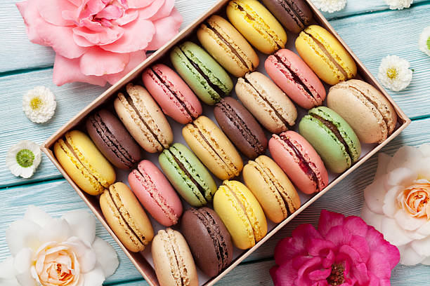 istock Colorful macaroons in a gift box and roses 618424336