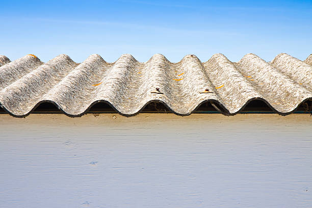 istock Wooden shack with a dangerous asbestos roof 618430016