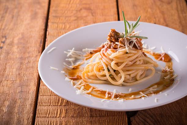 istock Plate with portion of spaghetti on wooden board 618431888
